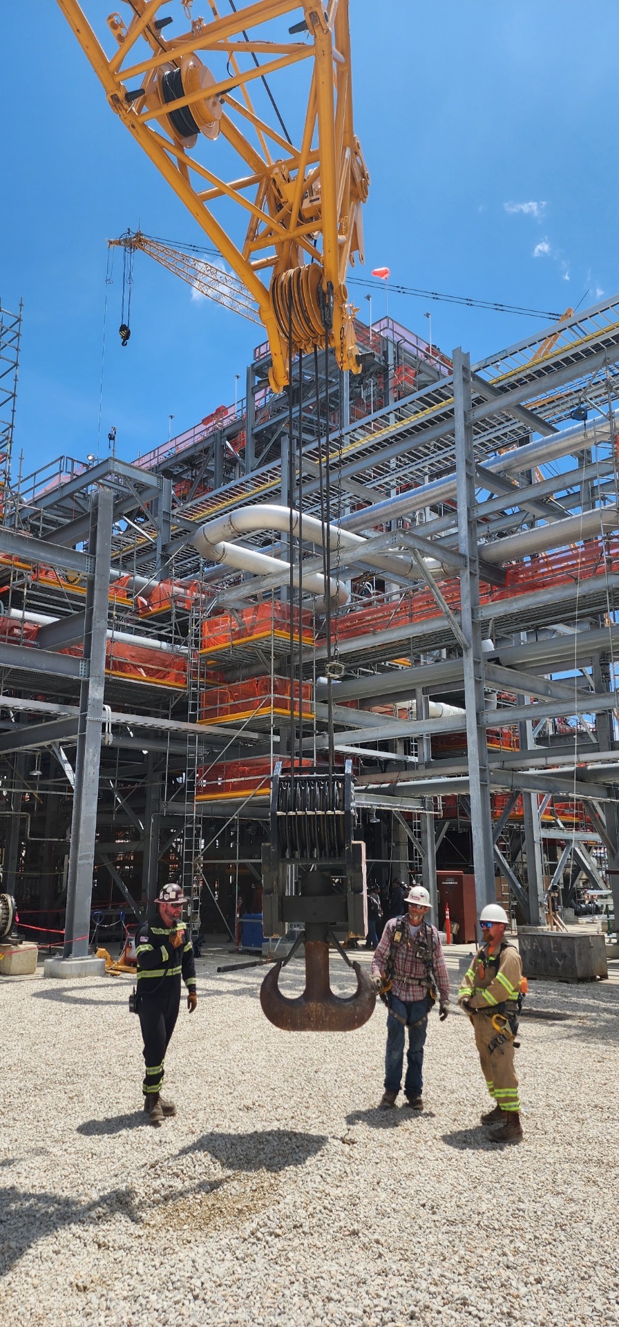 Crane hook and crew on an active job site